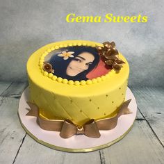 a yellow cake with an image of a woman on it and the words genna sweets