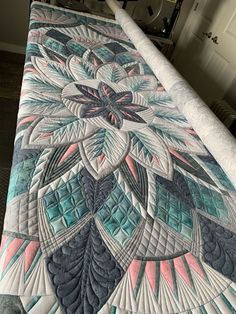 a quilted bedspread with an intricate design on it