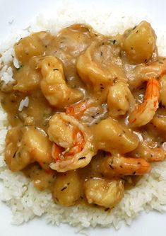 a white plate topped with rice and shrimp