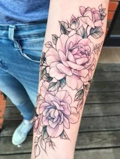 a woman's arm with flowers on it