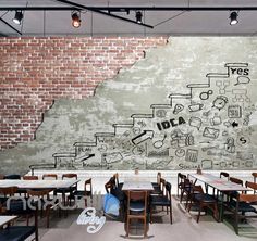 an empty restaurant with tables and chairs in front of a chalkboard mural on the wall