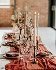 the table is set with candles and place settings