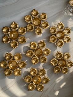 several gold plates are arranged on a table