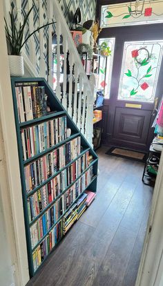 the stairs are full of books and magazines on display in this home's entryway