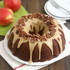 a bundt cake with pecans and caramel drizzle on top