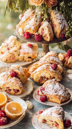 pastries, oranges and raspberries are on plates