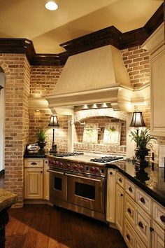 a kitchen with an oven, stove and sink in it's center island area