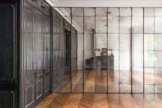 an empty room with mirrored walls and wooden floors