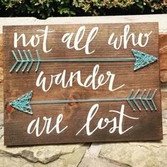 a wooden sign that says, not all who wander are lost