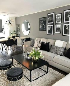 a living room filled with lots of furniture and pictures on the wall above it's coffee table