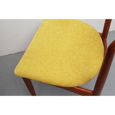 a wooden chair with a yellow seat cushion