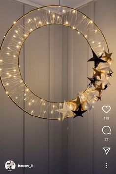 a lighted wreath with stars hanging from it