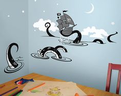 a child's room decorated in blue and white with pirate ship wall decals