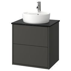 a white sink sitting on top of a black cabinet