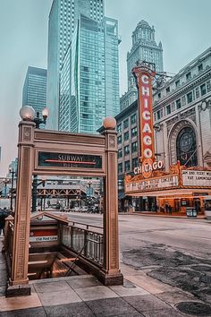 the chicago theater marquee is located in front of some tall buildings and skyscrapers