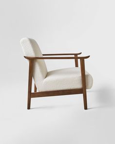 a white chair with a wooden frame and arm rest