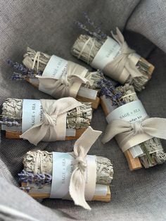 four bundles of lavender buds wrapped in twine and tied with ribbon on top of each other