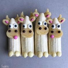 five bananas with fake eyes and ears are arranged in the shape of giraffes