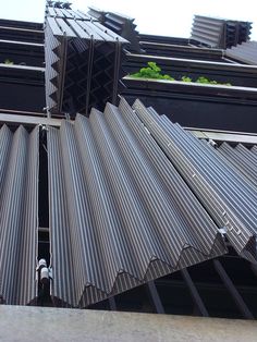 an open metal roof on top of a building with lots of steel bars sticking out of it