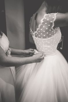 a woman in a dress getting ready to go into her wedding