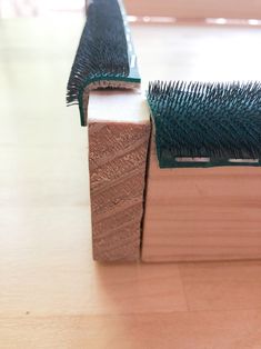 a close up of a book on a table with a hair brush sticking out of it