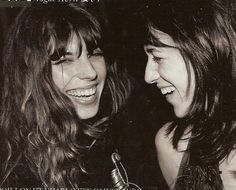 two young women laughing together in black and white with the caption, you can't tell what they are