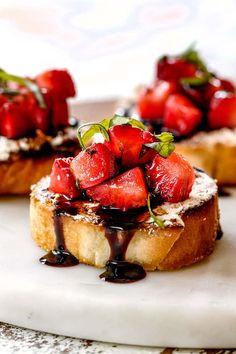 strawberries on toast with chocolate sauce drizzled over them