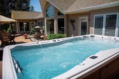 an outdoor hot tub in front of a house