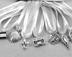 a bunch of charms sitting on top of a white cloth