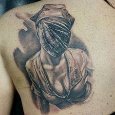 a woman's back with a tattoo on it that has an image of a person wearing a headdress