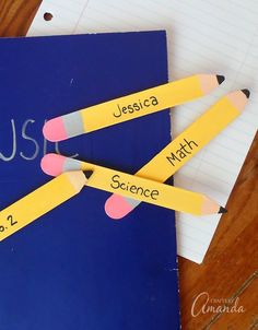 three pencils sitting on top of a notebook with the word music written on it