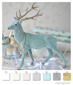 a blue deer figurine with gold antlers on it's head and chains around its neck