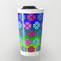 a colorful flower pattern on a white travel mug