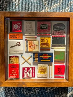 a shadow box filled with match boxes and matches