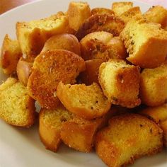 a white plate topped with fried potatoes on top of a table