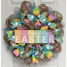 a happy easter wreath on the front door with colorful ribbons and letters that say happy easter