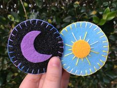 two handmade paper plates with the moon and the sun on them