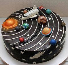 a birthday cake decorated with space and planets