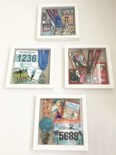 three white frames with pictures and medals hanging on the wall