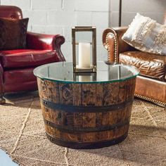 a wooden barrel table sitting on top of a rug