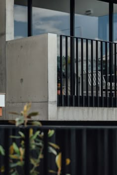 a man riding a skateboard down the side of a metal rail next to a building