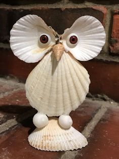 an owl figurine made out of seashells