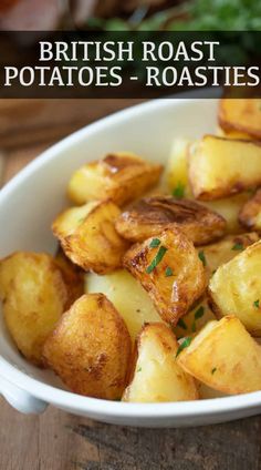 a white bowl filled with potatoes on top of a wooden table