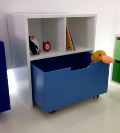 a toy storage unit with toys in it and an orange duck sitting on the top