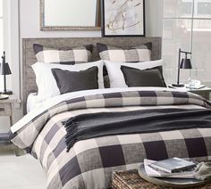 a bed with black and white checkered comforter