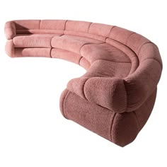 a pink couch sitting on top of a white floor