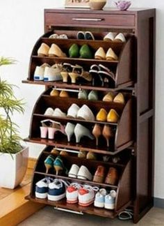 the shoe rack is made out of wood and holds several pairs of shoes on it