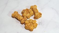 five pieces of food sitting on top of a white counter