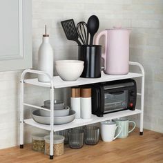 a white shelf with various kitchen utensils on it