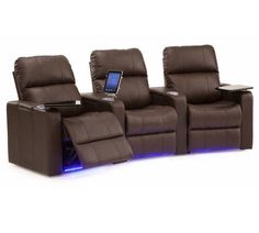 two recliners with electronic devices on them sitting side by side in front of each other